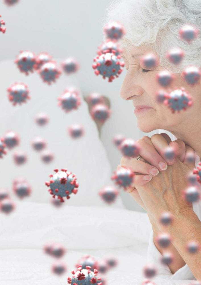 Elderly woman with closed eyes and folded hands, surrounded by floating virus particles, symbolizing vulnerability to illness.